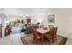 An open-concept living room with dining space and access to the screened-in patio at 9850 Fiddlers Green Cir # 130, Rotonda West, FL 33947