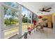 Screened-in patio with ceiling fan, tile flooring, seating, and a view of the backyard at 9850 Fiddlers Green Cir # 130, Rotonda West, FL 33947