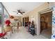 Enclosed patio with ceiling fan, golf supplies, access to interior space, and views of the garden at 9850 Fiddlers Green Cir # 130, Rotonda West, FL 33947