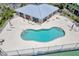 Aerial view of a community pool surrounded by ample seating and well-maintained grounds at 9850 Fiddlers Green Cir # 130, Rotonda West, FL 33947