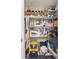 Storage closet featuring pegboard and wire shelving filled with tools and storage containers at 9850 Fiddlers Green Cir # 130, Rotonda West, FL 33947