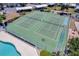 Aerial view of community tennis courts and shuffleboard near the community pool at 9850 Fiddlers Green Cir # 130, Rotonda West, FL 33947