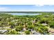 Neighborhood with mature trees, manicured lawns, single-Gathering homes, and a large lake in the distance at 1102 Hunt Club Ln, Valrico, FL 33594