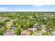 Expansive aerial view of a residential neighborhood featuring lush green trees and well-maintained homes at 1102 Hunt Club Ln, Valrico, FL 33594