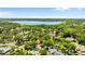 Neighborhood with mature trees, manicured lawns, single-Gathering homes, and a large lake in the distance at 1102 Hunt Club Ln, Valrico, FL 33594