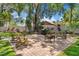 Lush backyard featuring a brick patio with outdoor seating and mature trees at 1102 Hunt Club Ln, Valrico, FL 33594