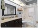Bright bathroom featuring granite countertops, dark cabinets, and tiled shower-tub combo at 1102 Hunt Club Ln, Valrico, FL 33594