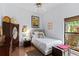Cozy bedroom with natural light featuring wood floors, wardrobe and chest of drawers at 1102 Hunt Club Ln, Valrico, FL 33594