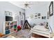 Charming bedroom with a colorful rug, play tent, and white-painted furniture at 1102 Hunt Club Ln, Valrico, FL 33594