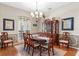 Elegant dining room with hardwood floors, a chandelier, and a classic china cabinet, perfect for entertaining at 1102 Hunt Club Ln, Valrico, FL 33594