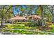 Charming single-story home featuring mature landscaping and a neutral color palette at 1102 Hunt Club Ln, Valrico, FL 33594