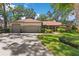 Charming single-story home with a three-car garage, mature landscaping, and a well-manicured lawn at 1102 Hunt Club Ln, Valrico, FL 33594