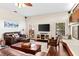 Cozy living room with leather sofas, wood floors, and abundant natural light at 1102 Hunt Club Ln, Valrico, FL 33594