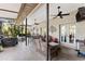 Comfortable outdoor patio with wicker seating, ceiling fans, and a view of lush greenery at 1102 Hunt Club Ln, Valrico, FL 33594