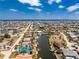 Aerial view of a home with a pool, dock, and canal access in a residential neighborhood at 1134 Coronado Dr, Punta Gorda, FL 33950