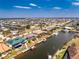 Stunning aerial view of a waterfront home featuring a pool, dock, and solar panels in a desirable community at 1134 Coronado Dr, Punta Gorda, FL 33950