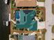 Drone view of waterfront home featuring a screened-in pool, and canal access at 1134 Coronado Dr, Punta Gorda, FL 33950