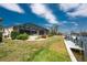 The backyard of this waterfront home features a screened enclosure and a boat dock at 1134 Coronado Dr, Punta Gorda, FL 33950