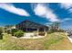 The backyard of this waterfront home features a screened enclosure and lush landscaping at 1134 Coronado Dr, Punta Gorda, FL 33950