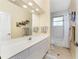 Clean bathroom featuring vanity with storage, a large mirror with overhead lighting and a tub/shower combo at 1134 Coronado Dr, Punta Gorda, FL 33950