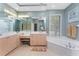 Light-filled bathroom featuring dual sinks, bathtub, and a window for natural light at 1134 Coronado Dr, Punta Gorda, FL 33950