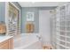 This bathroom features a soaking tub, a glass block wall, and a picture window at 1134 Coronado Dr, Punta Gorda, FL 33950