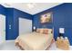 Inviting bedroom with blue walls, a ceiling fan, and a comfortable bed, creating a relaxing atmosphere at 1134 Coronado Dr, Punta Gorda, FL 33950