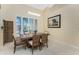 Bright dining room with large windows, plantation shutters, and a stylish wooden table and chairs at 1134 Coronado Dr, Punta Gorda, FL 33950