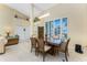 Open dining area with high ceilings, natural light, and an adjacent living space for seamless entertaining at 1134 Coronado Dr, Punta Gorda, FL 33950
