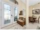 Warm and inviting foyer with tile flooring, a decorative bench, and a view of the dining area at 1134 Coronado Dr, Punta Gorda, FL 33950
