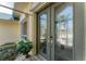 Elegant front door with decorative glass inserts, complemented by a green trim and tropical plants at 1134 Coronado Dr, Punta Gorda, FL 33950