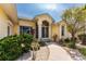 Close-up of the front entrance featuring a walkway and vibrant tropical plants at 1134 Coronado Dr, Punta Gorda, FL 33950