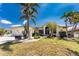Charming single-story home with a well-manicured lawn and mature palm trees at 1134 Coronado Dr, Punta Gorda, FL 33950