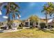 Inviting one-story home with lush tropical landscaping and a well-maintained lawn at 1134 Coronado Dr, Punta Gorda, FL 33950