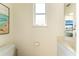 Cozy half bathroom with a bright window, vanity, and serene decor, providing a convenient space for guests at 1134 Coronado Dr, Punta Gorda, FL 33950