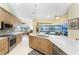 Open kitchen featuring stainless steel appliances, granite countertops, island sink, and views to the living room at 1134 Coronado Dr, Punta Gorda, FL 33950