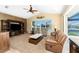 Comfortable living room with plush seating, a ceiling fan, a waterfront view, and sliding door to the pool at 1134 Coronado Dr, Punta Gorda, FL 33950