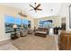 Bright living room featuring vaulted ceilings, fan, comfortable seating, and expansive windows with water views at 1134 Coronado Dr, Punta Gorda, FL 33950
