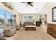 Living room with water views, plush seating, vaulted ceilings, tile flooring, and decor over windows and sliders at 1134 Coronado Dr, Punta Gorda, FL 33950