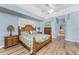 Light and bright main bedroom boasts a wooden bed frame and hardwood floors at 1134 Coronado Dr, Punta Gorda, FL 33950