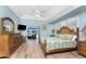 Spacious main bedroom with wood floors, pool view access, and ample natural light, creating a serene retreat at 1134 Coronado Dr, Punta Gorda, FL 33950