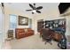 Comfortable home office featuring a leather sofa, desk with storage, and natural light streaming through the windows at 1134 Coronado Dr, Punta Gorda, FL 33950