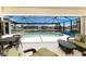 Screened-in pool and patio with views of the canal and neighboring homes at 1134 Coronado Dr, Punta Gorda, FL 33950