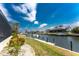 Lovely waterfront view featuring a canal, boat dock, and lush green landscaping at 1134 Coronado Dr, Punta Gorda, FL 33950