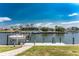 Scenic waterfront view of a home with a boat lift and dock on a sunny day at 1134 Coronado Dr, Punta Gorda, FL 33950