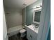 Updated bathroom with a shower over tub, vanity, modern mirror and lighting at 1258 Barbara Dr # 202, Venice, FL 34285