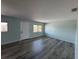 Spacious living room featuring wood floors and large windows providing ample natural light at 1258 Barbara Dr # 202, Venice, FL 34285