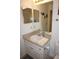 Bathroom vanity with ample lighting, a mirror, and sink with counter space at 1295 Saxony Cir # 2101, Punta Gorda, FL 33983