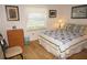 Cozy bedroom with natural light, wooden floors, and comfortable furnishings at 1295 Saxony Cir # 2101, Punta Gorda, FL 33983