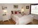 Cozy bedroom with a queen bed, side tables, and art at 1295 Saxony Cir # 2101, Punta Gorda, FL 33983